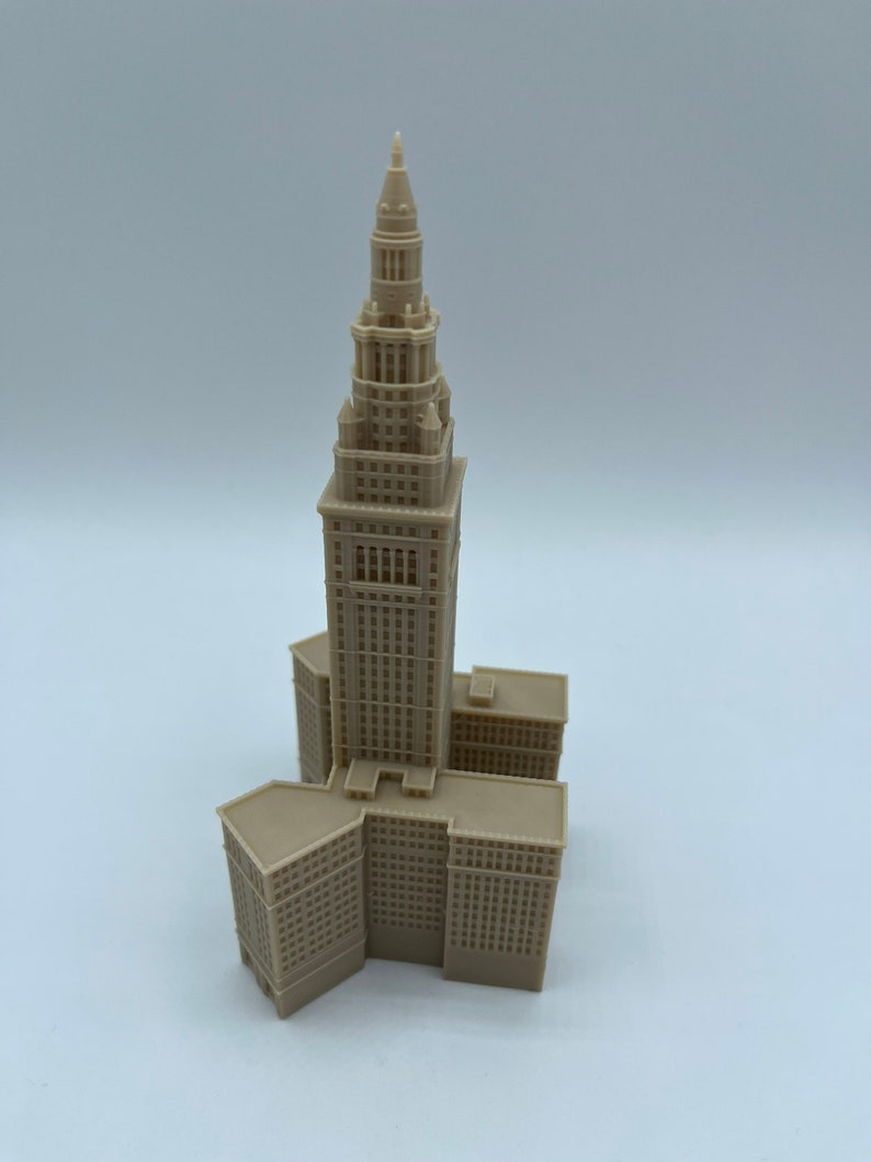 May include: A beige 3D printed model of the Terminal Tower in Cleveland, Ohio. The model is detailed and includes the tower's distinctive spire.