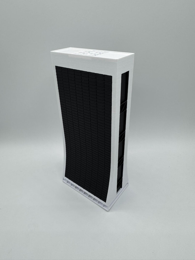 May include: A white model of a tall, modern building with a black grid pattern on the front. The building has a slightly curved shape.