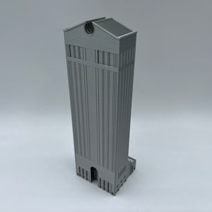 May include: A gray 3D printed model of a tall building with a flat roof and a detailed facade.