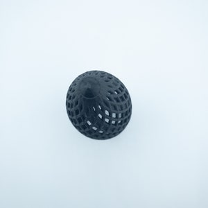 May include: A black, 3D printed, geometric sphere with a lattice design.
