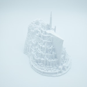 May include: A white 3D printed model of a fantasy city with a tall tower, resembling a fictional castle.