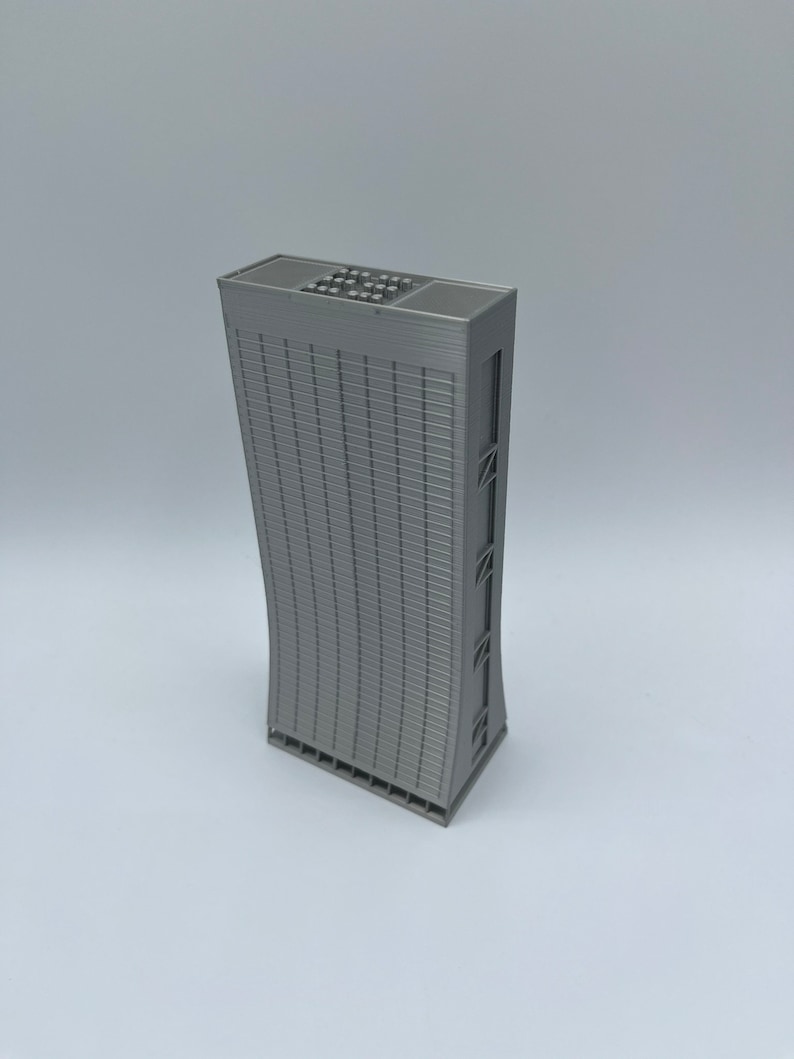 May include: A gray 3D printed model of a tall, modern skyscraper with a curved facade and a flat roof.