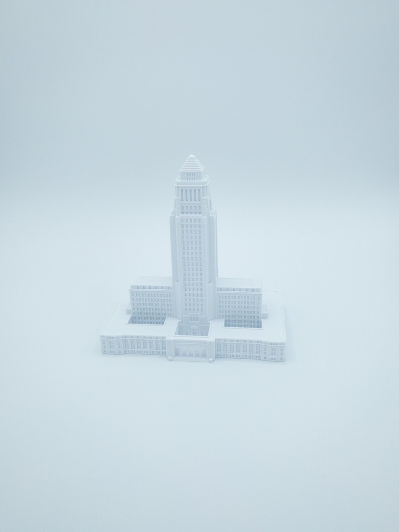 May include: A white 3D printed model of a city hall building.