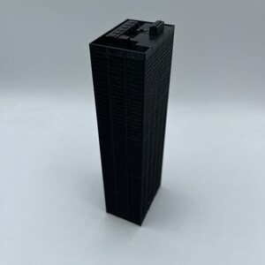 May include: A black 3D printed model of a skyscraper.