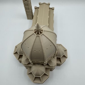 May include: A beige 3D-printed model of the Florence Cathedral, featuring the iconic dome and bell tower. The model showcases architectural details, including the dome's design and the tower's windows. The model is a detailed replica of the famous Italian landmark.