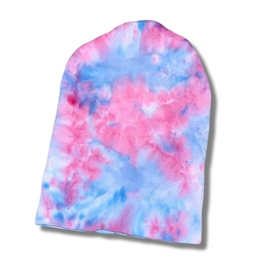 May include: A tie-dye beanie in shades of pink and blue. The hat is made of soft fabric and features a unique, swirled pattern. The beanie is a comfortable and stylish accessory.