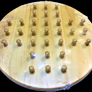 May include: A wooden game board with 45 pegs, arranged in a diamond pattern. The board is circular and has a natural wood finish.