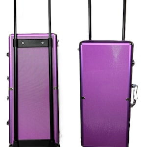 May include: A purple rolling makeup case with a textured surface, black handle, and wheels. The image shows the back and front sides of the case. The back side is labeled "Back Side" and the front side is labeled "Front Side".