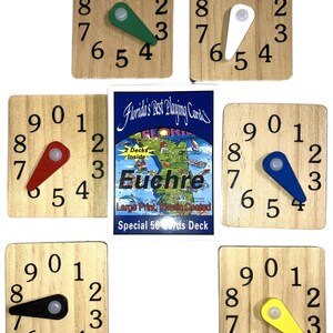 May include: Wooden clock-face game pieces with numbers 0-9 and colored hands. A deck of "Euchre" playing cards is in the center. The game pieces are square and made of light-colored wood.