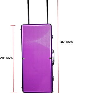 May include: A purple rolling suitcase with a telescoping handle. The suitcase is 36 inches tall, 20 inches wide, and 9 inches deep. It has a textured surface and is designed for travel.