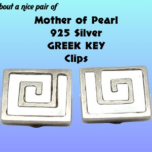 May include: A pair of silver Greek key earrings with mother of pearl inlays. The earrings are square shaped and have a white enamel design.