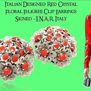 Könnte beinhalten: Italienisch gestaltete rote Kristall-Blumen-Filigran-Clip-Ohrringe. Die Ohrringe haben ein silberfarbenes Metalldesign mit roten Kristallakzenten. Der Text auf dem Bild lautet: "ITALIAN DESIGNED RED CRYSTAL FLORAL FILIGREE CLIP EARRINGS SIGNED - I.N.A.R. ITALY."