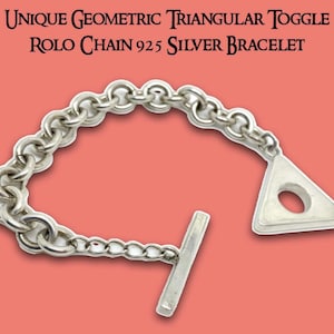 May include: A silver Rolo chain bracelet with a unique geometric triangular toggle clasp. The bracelet is made of 925 silver and features a series of interconnected circular links. The toggle clasp is a triangle shape with a circular hole.