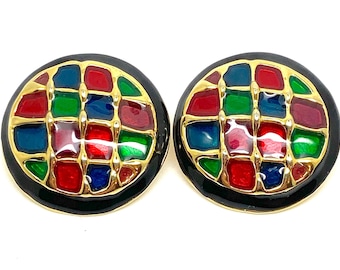 May include: A pair of gold tone earrings with a black enamel background. The earrings feature a colorful geometric design with red, green, blue, and gold accents.