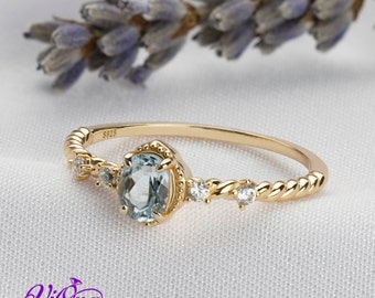 Oval Blue Topaz Gemstone Radiance: Gold-Plated 925 Sterling Silver Ring with 4 Side Stones and Intricate Rope Detailing