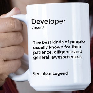 May include: White ceramic mug with a black design that reads "Developer /noun/ The best kinds of people usually known for their patience, diligence and general awesomeness. See also: Legend"