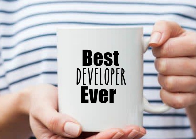 May include: White ceramic mug with black text that reads "Best Developer Ever".