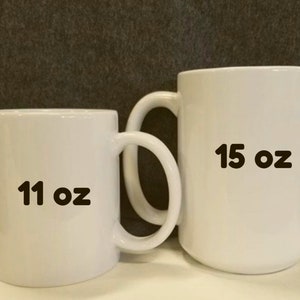 May include: Two white ceramic mugs, one is 11 oz and the other is 15 oz.