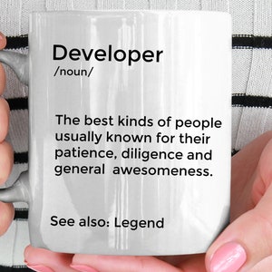 May include: White ceramic mug with black text that reads "Developer /noun/ The best kinds of people usually known for their patience, diligence and general awesomeness. See also: Legend"