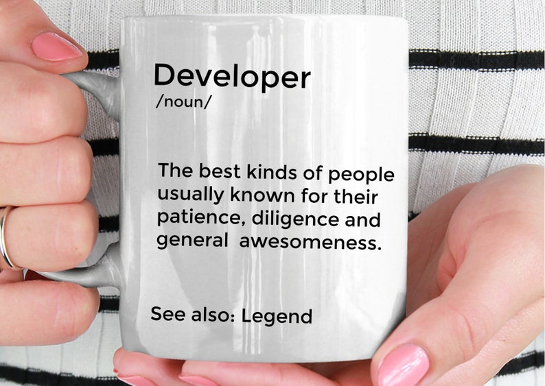 May include: White ceramic mug with black text that reads "Developer /noun/ The best kinds of people usually known for their patience, diligence and general awesomeness. See also: Legend"