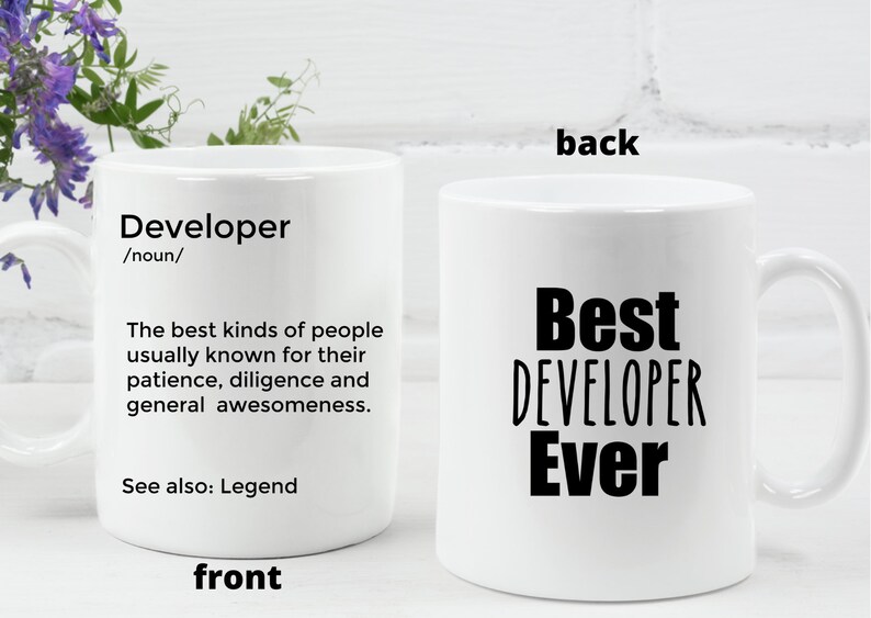 May include: White ceramic coffee mug with a black design. The front of the mug reads "Developer /noun/ The best kinds of people usually known for their patience, diligence and general awesomeness. See also: Legend". The back of the mug reads "Best DEVELOPER Ever".