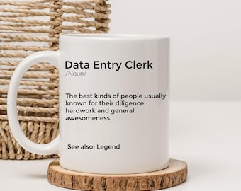 May include: White ceramic mug with a black design that reads "Data Entry Clerk /Noun/ The best kinds of people usually known for their diligence, hardwork and general awesomeness See also: Legend"