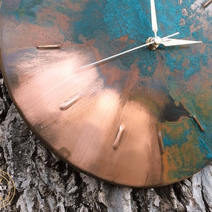 Industrial Handmade Old Copper Wall Clock with Silver Colored Hands hanging on a tree under natural sunlight by Copper Empire