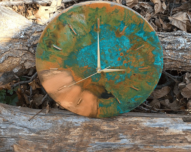 Farmhouse Handmade Old Copper Wall Clock with Gold Colored Hands on a natural wooden background under natural sunlight by Copper Empire