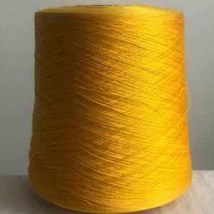 May include: A cone of bright yellow yarn.