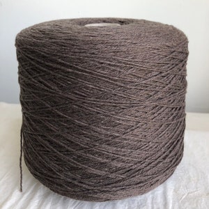 May include: A skein of dark brown yarn wound into a ball shape.