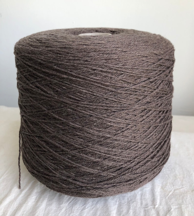 May include: A skein of dark brown yarn wound into a ball shape.