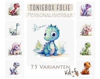 May include: A set of 9 colorful dinosaur illustrations, including a blue, green, and orange dinosaur, a purple dinosaur with a horn, and a red dinosaur. The illustrations are on a white background with the text "TONIEBOX FOLIE PERSONALISIERBAR" and "75 VARIANTEN Kid*E" in the bottom right corner.