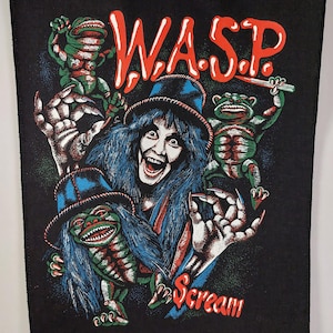 May include: Black patch with a vibrant graphic of a screaming figure with blue hair and a hat, flanked by green creatures. The red text reads "W.A.S.P." above the figure and "Scream" below.