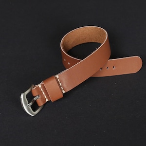 May include: A brown leather watch strap with white stitching and a silver buckle.
