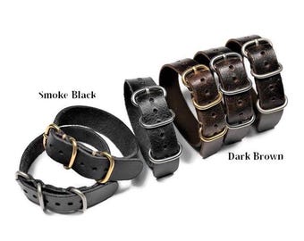 May include: Two leather watch straps, one in smoke black and one in dark brown. Both straps have a double keeper and are made with a perforated design.