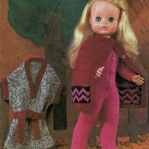 May include: A knitted doll outfit with a pink and black chevron pattern on the sleeves and a matching pink and black chevron pattern on the pants. The outfit includes a pink knitted dress with a matching pink knitted cape.