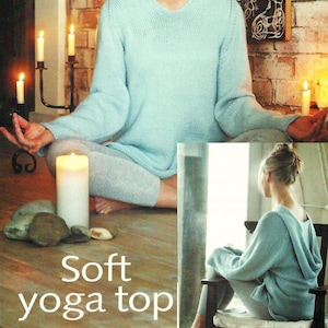 May include: A light blue knitted yoga top with a v-neck and long sleeves. The model is wearing the top and sitting in a yoga pose.