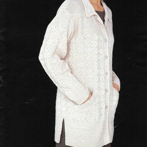 May include: A white knitted cardigan with a button-up front and pockets. The cardigan has a textured pattern and a collared neckline.