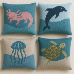 Könnte beinhalten: Vier quadratische Zierkissen mit Designs von Meeresbewohnern. Ein Kissen zeigt einen rosa Axolotl, ein anderes einen springenden Delfin, ein drittes eine blaue Qualle und das letzte eine grüne Meeresschildkröte. Alle auf blauem oder beigem Hintergrund.