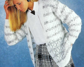 May include: A white open-front cardigan with a diamond pattern and gray accents. The cardigan is paired with a white collared shirt and black and white plaid pants. The outfit is set against a blue background.