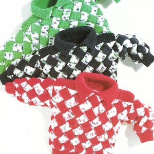 May include: Three knitted jumpers with a checkered pattern in green, black, and red. The jumpers have a white background and a contrasting colour for the squares.