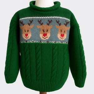 May include: Green cable-knit sweater with a roll neck collar. The sweater features a light blue band with three reindeer faces with brown antlers and red noses. A white and green pattern borders the reindeer design.