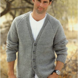 May include: A gray knitted cardigan with a V-neck and button closure. The cardigan has long sleeves and a ribbed texture.