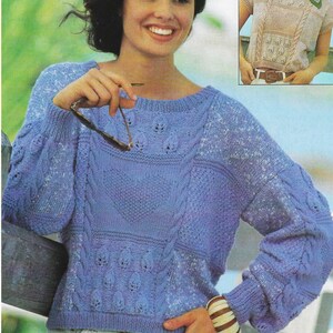 May include: Two women wearing knitted sweaters. The woman on the left is wearing a light blue sweater with a cable knit pattern. The woman on the right is wearing a beige sweater with a similar pattern.