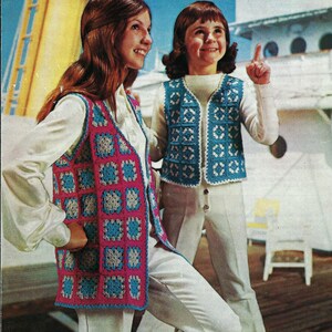 May include: Two crocheted vests with a geometric pattern in shades of pink, blue, and white. The vests are worn by two people standing in front of a white background.
