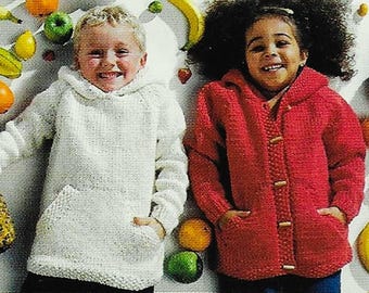 May include: Two children wearing knitted sweaters. The girl is wearing a red sweater with buttons and the boy is wearing a white sweater with a pocket. The children are surrounded by fruit.
