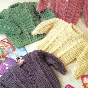 May include: Four knitted sweaters in different colors: green, pink, yellow, and purple. Each sweater has a cable knit pattern and button closures.