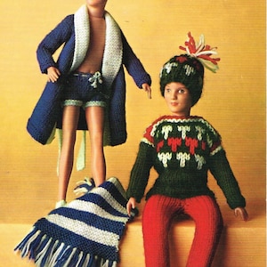 May include: Two knitted doll outfits. One outfit is a blue robe with a white collar and matching blue shorts. The other outfit is a green sweater with a red and white geometric pattern, red pants, and a green and white hat with a red and white pom-pom.