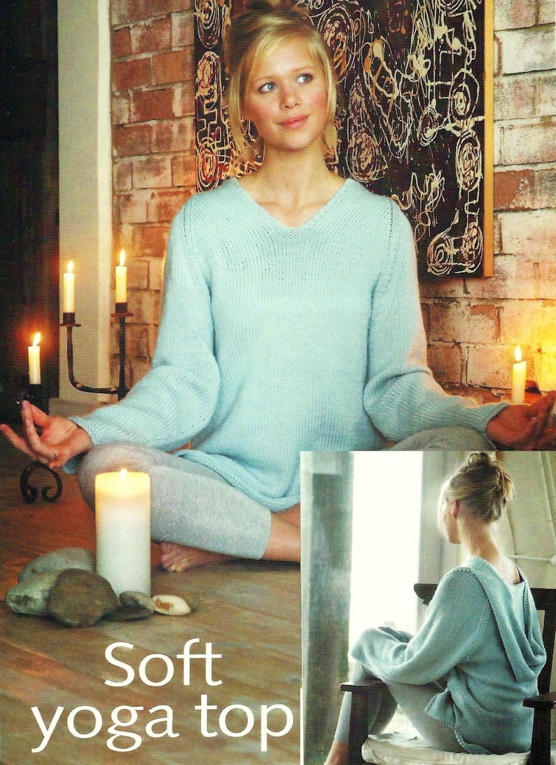 May include: A light blue knitted yoga top with a v-neck and long sleeves. The model is wearing the top and sitting in a yoga pose.