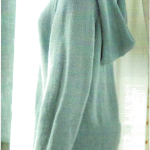 May include: A light blue hooded sweater with a relaxed fit. The sweater is made of a soft, knit fabric.